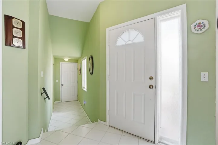 Entrance foyer with healthy amount of natural light and light tile patterned flooring
