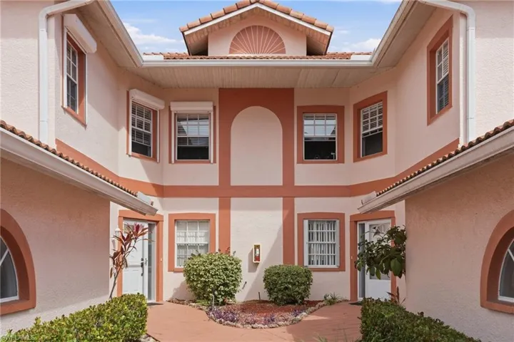 Doorway to property with stucco siding and a tile roof