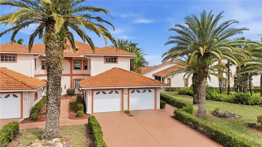 Mediterranean / spanish house featuring stucco siding, decorative driveway, a tile roof, and a front lawn