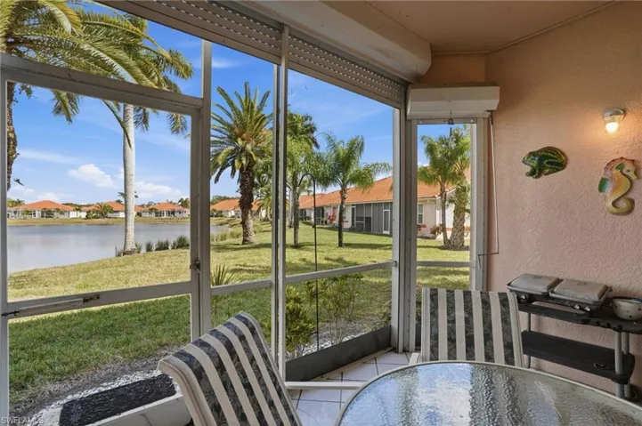 Sunroom / solarium featuring a residential view and a water view