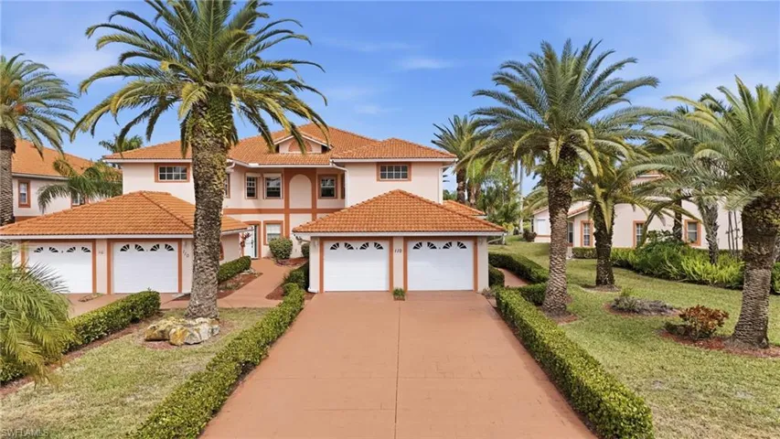 View of front of home with stucco siding, a tile roof, a garage, concrete driveway, and a front yard