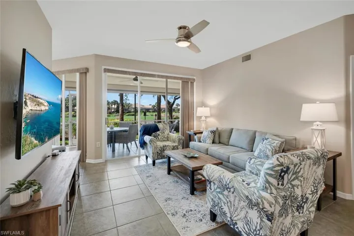 Tiled living room featuring ceiling fan