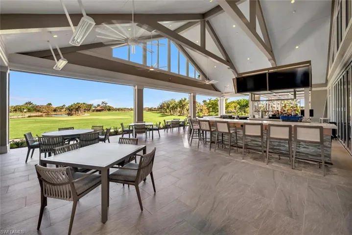 View of clubhouse outdoor bar area overlooking 18th hole