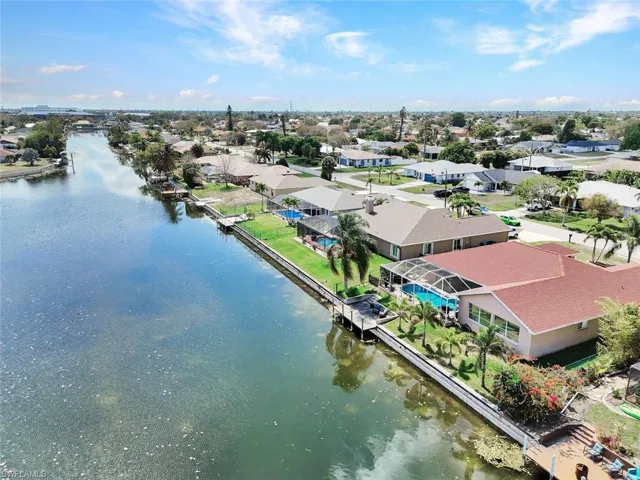 Aerial view of residential area featuring a large body of water