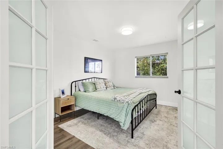 Bedroom 2 featuring wood finished floors and baseboards