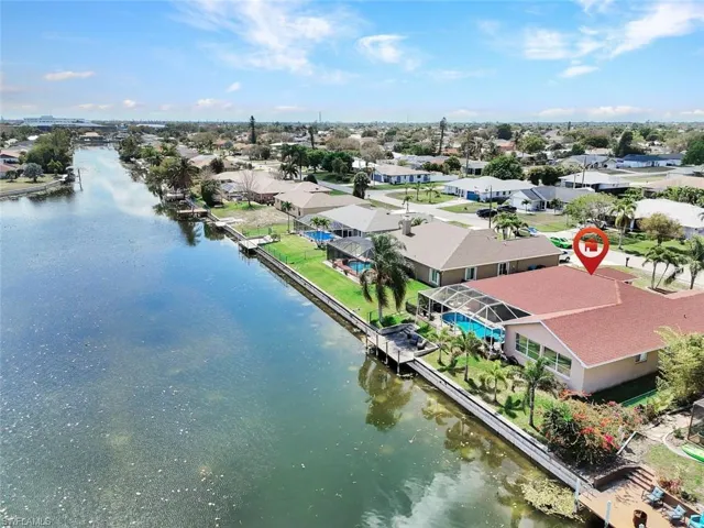 Aerial perspective of suburban area featuring a large body of water