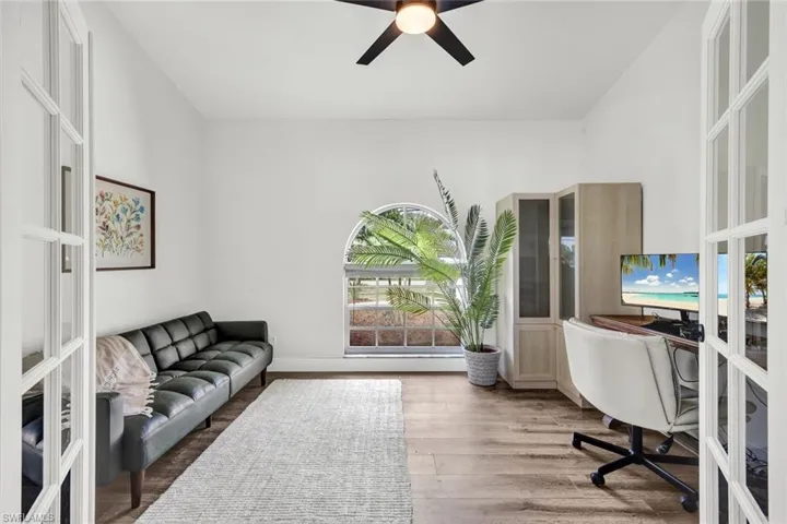 Home office/ Bedroom 5 with a ceiling fan and light wood-style floors