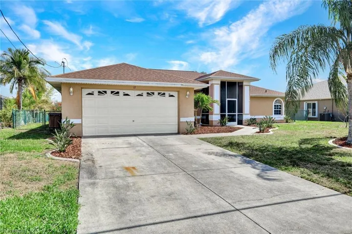 Ranch-style home with stucco siding, a front lawn, an attached garage, concrete driveway, and a sunroom