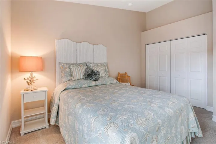 Carpeted bedroom featuring a closet
