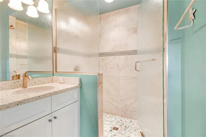 Bathroom with walk in shower and vanity