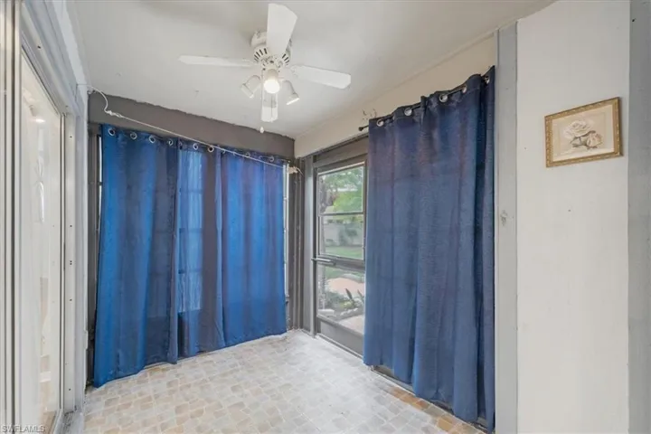 Tiled empty room with ceiling fan