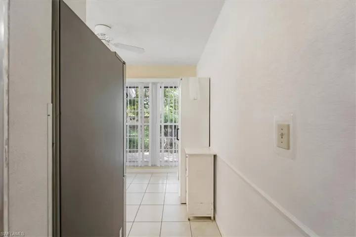 Hallway with light tile floors