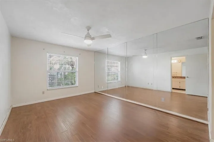 Spare room featuring ceiling fan and hardwood / wood-style floors