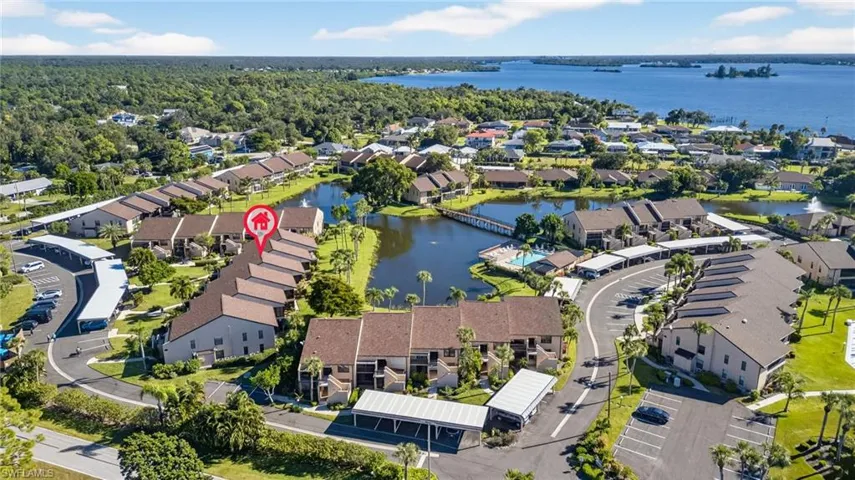 Aerial view of property and surrounding area with a nearby body of water