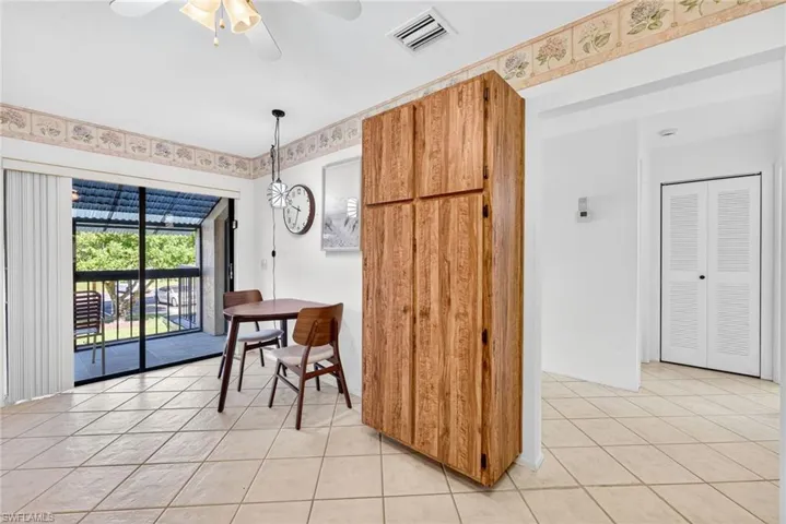 Dining room with light tile patterned floors and a ceiling fan