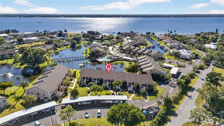 Aerial view of residential area featuring a nearby body of water