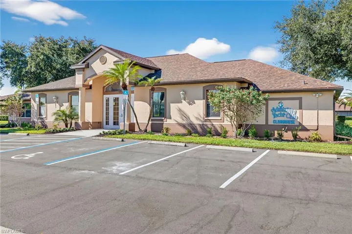 View of property with uncovered parking