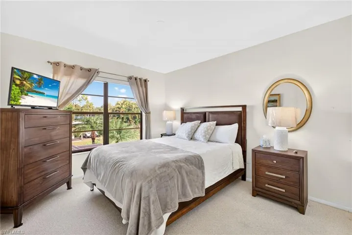 Bedroom featuring light colored carpet and baseboards