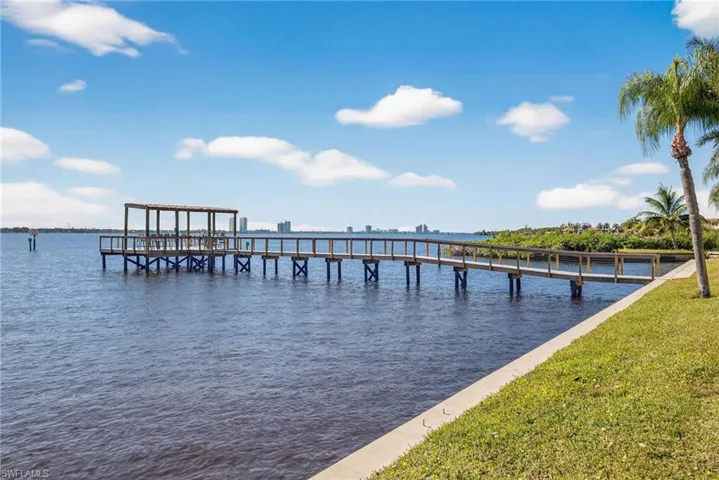 Dock featuring a water view and a yard