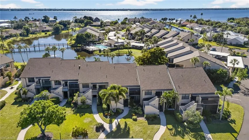 Aerial view of residential area featuring a nearby body of water