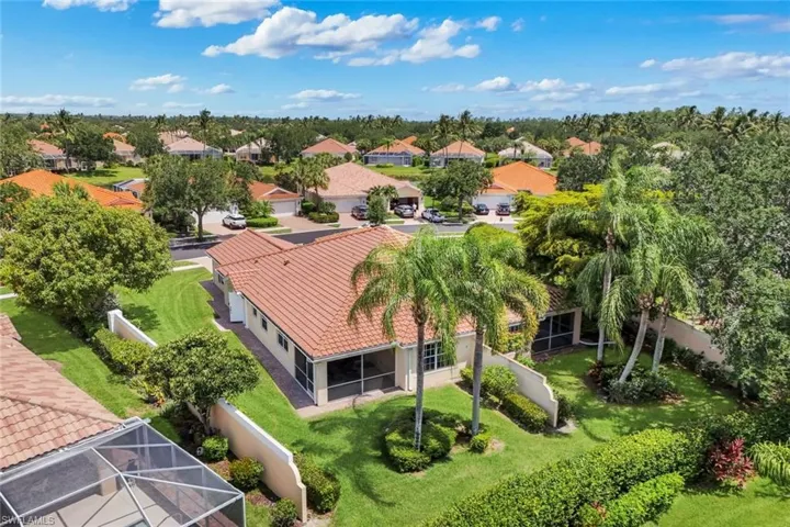 Aerial perspective showcasing a residential property with a tiled roof and screened-in patio