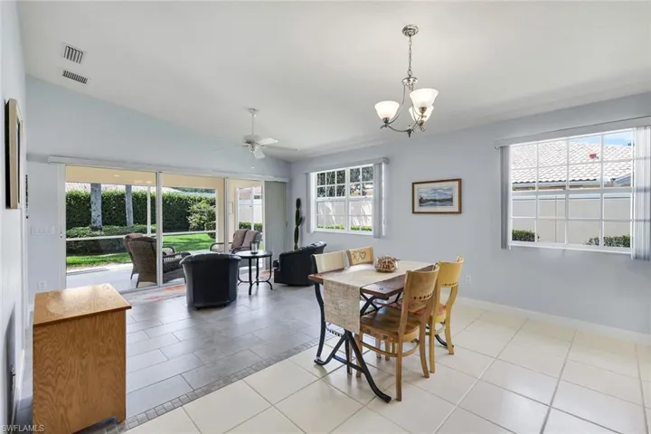 Screened patio with large format tile flooring and a ceiling fan