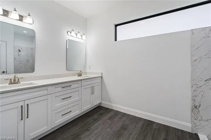 Bathroom featuring hardwood / wood-style floors and dual bowl vanity