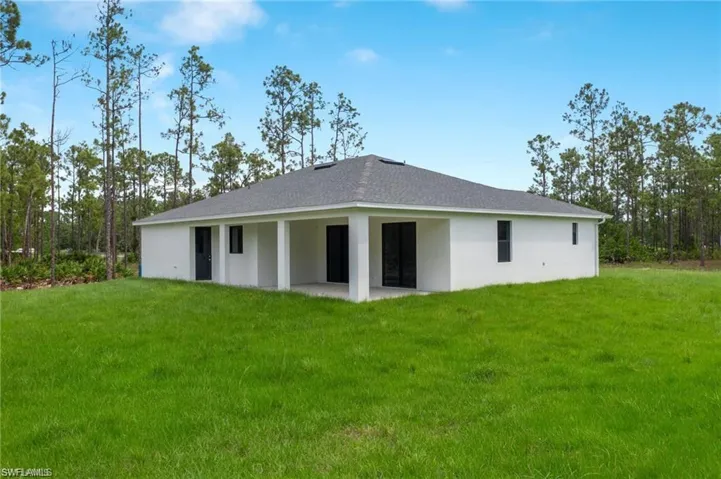 Back of house featuring a yard