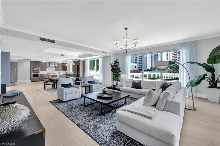 The large great room offers floor to ceiling windows with so much gathering space for friends and family.