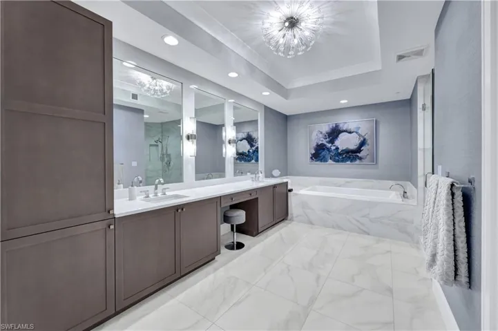 Dual sinks, spacious shower and a large soaking tub. Pull out drawers were recently added along with granite framing around the mirrors. Bathroom also boasts custom lighting.