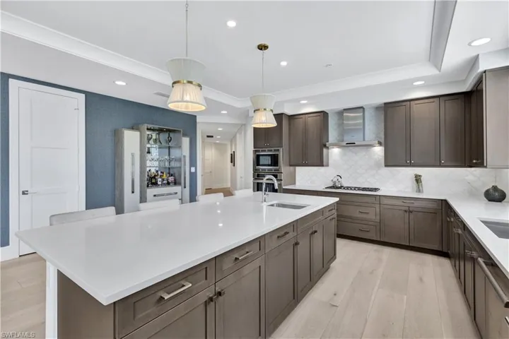 Pantry to the left of liquor/wine cabinet.  The primary bedroom suite is on the west side of the home, and the two guest bedrooms with en-suite bathrooms are on the east side of the home, allowing for maximum privacy.