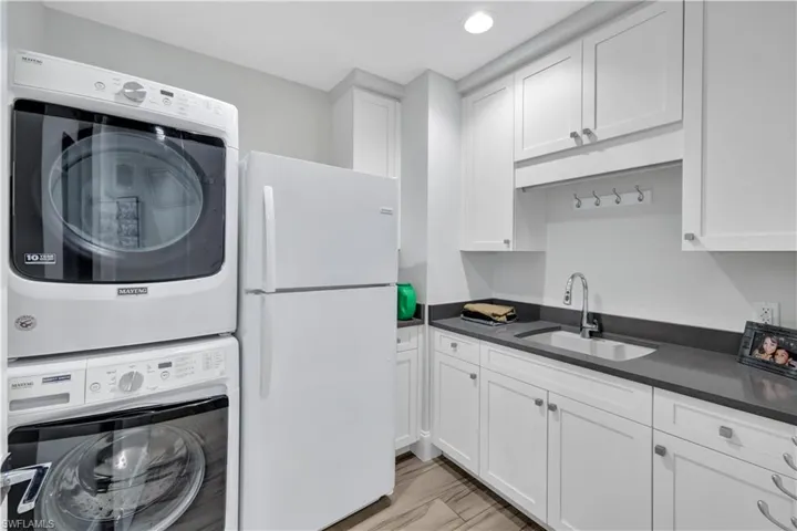 OVERSIZED laundry with space for a second refrigerator.