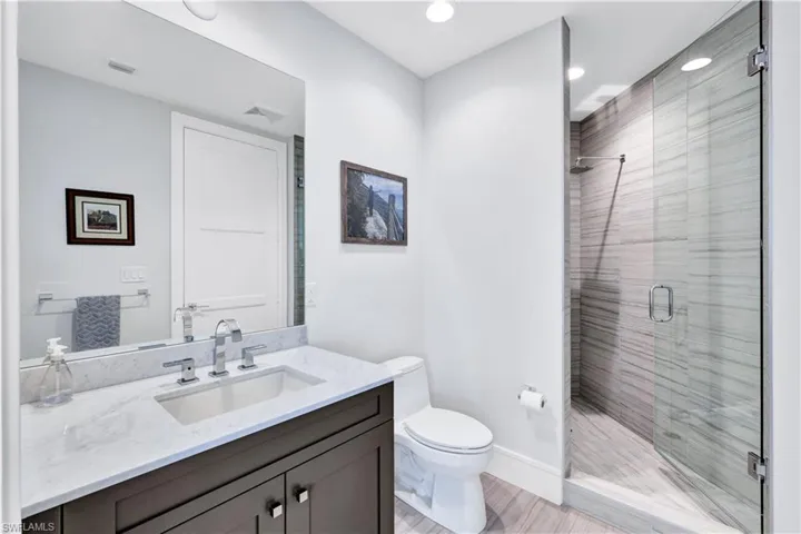 En-suite guest bathroom with walk in shower and ample cabinet space.