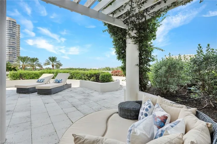 The coveted end unit in Seaglass - the ONLY home on the South side pf the building with so much outdoor space and easy pool access!