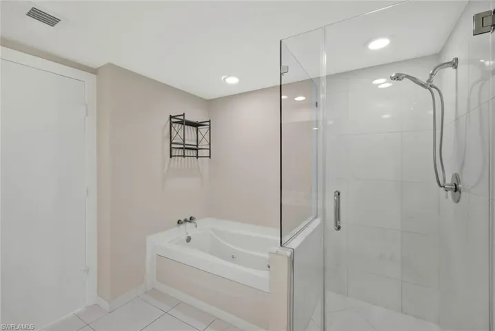 Master Bathroom featuring walk in shower  + separate bath tub