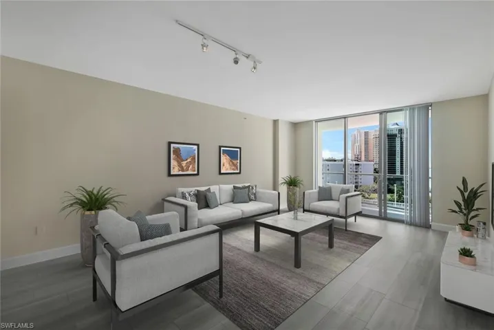 Open plan Living room with a wall of windows, large balcony with river and pool deck views, luxury vinyl flooring wood-type flooring - virtual staged