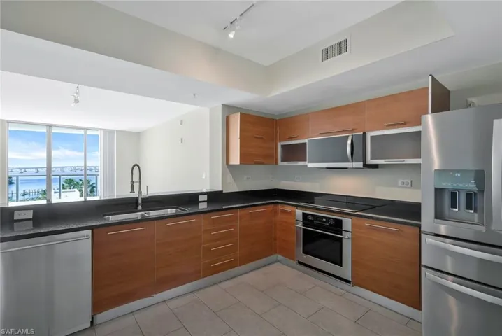 The modern open plan Kitchen with views over the living area and out to the balcony