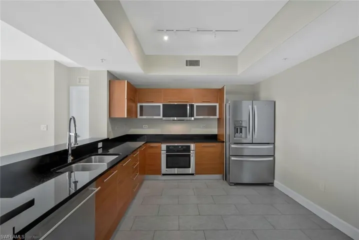 Open plan Kitchen featuring stainless steel appliances and breakfast bar