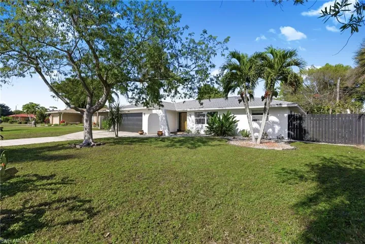 Ranch-style house with stucco siding, driveway, and a garage