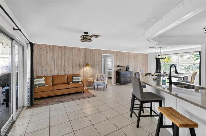 Living area featuring wooden walls and light tile patterned flooring