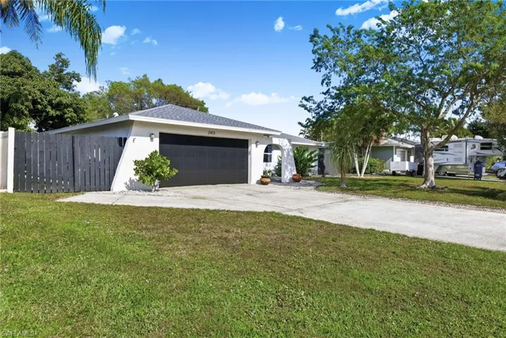 Ranch-style house with concrete driveway, stucco siding, and a garage
