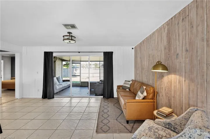 Tiled living area featuring wooden walls