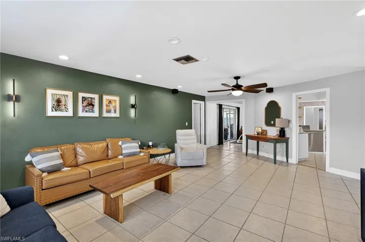 Living area with recessed lighting, a ceiling fan, and light tile patterned flooring