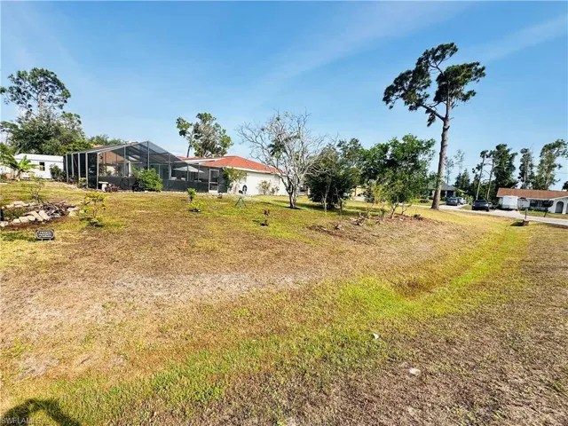 View of yard featuring glass enclosure