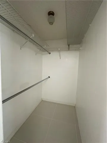 Walk in closet featuring light tile patterned flooring