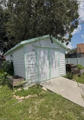 View of shed with a vegetable garden