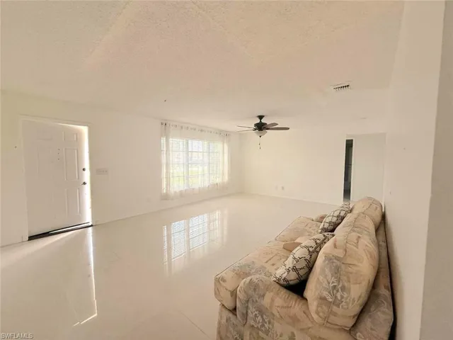 Living area featuring a textured ceiling and tile patterned floors