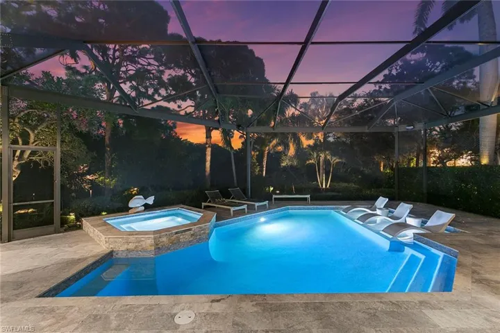Combined pool / hot tub featuring a lanai, a patio, and a sunroom
