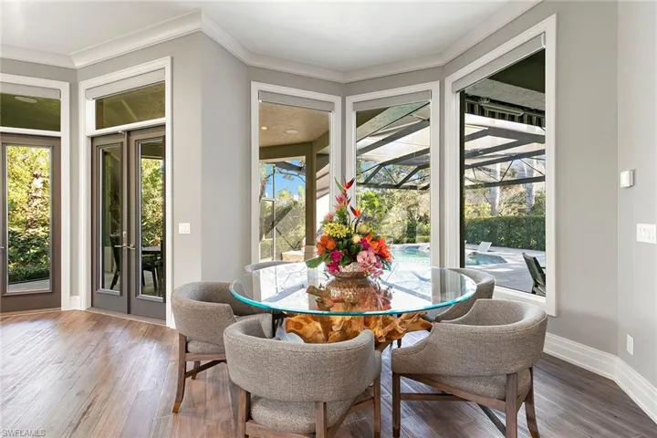 Dining space featuring a sunroom and wood finished floors