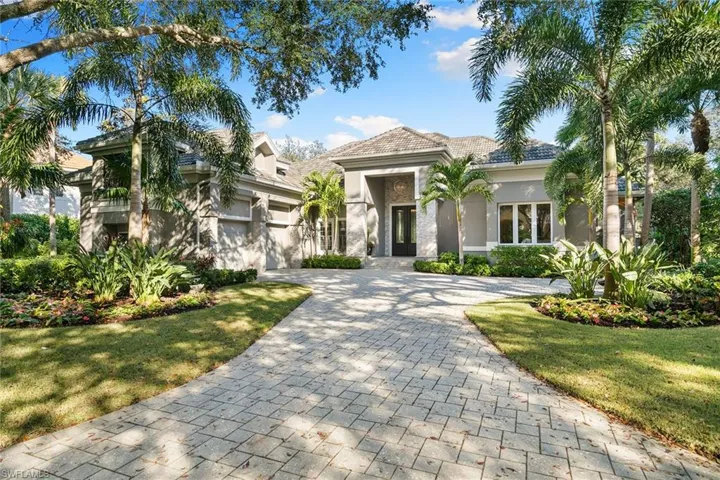 View of front of house featuring stucco siding, decorative driveway, a garage, and a front yard